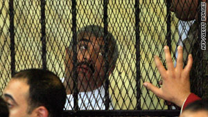 Egyptian tycoon Hisham Talaat Mustafa inside the defendants' cage during his trial in Cairo.