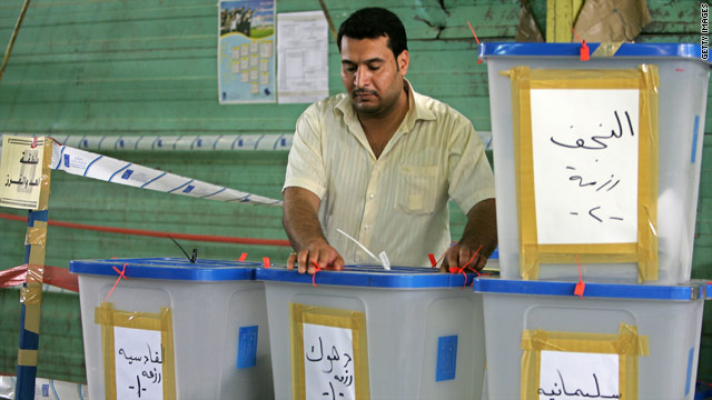 An Iraqi electoral worker with ballot boxes at a counting center in Baghdad, Iraq on March 17, 2010.