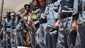 Afghan border policemen stand guard by landmines discovered near the Iranian border in 2007.