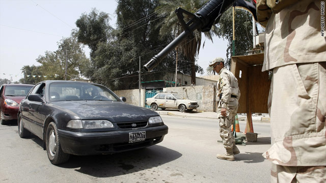 Soldiers stop vehicles at a checkpoint in Baghad on Saturday after an attack that killed 25 people.
