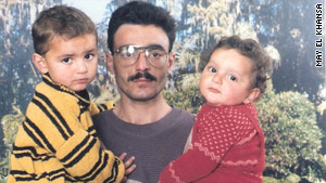 Ali Hussain Sibat pictured with two of his five children.