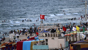 Palestinians gather on the beach in Gaza City about a week after an Israeli attack on a Gaza-bound aid flotilla.