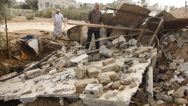 Palestinians  inspect the aftermath of an Israeli airstrike on Rafah in Gaza. The Israeli military said the attack was in response to mortars fired into Israel.