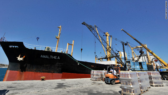 Workers load supplies on to a cargo ship at the Lavrio port, southeast of Athens, Greece, on Friday.