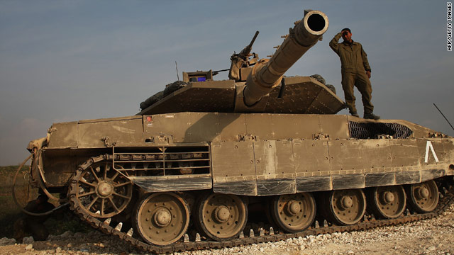 An Israeli soldier stands on top of a tank on January 17, 2009, along the Gaza-Israeli border.