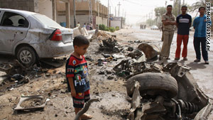 Iraqis gather at the site of a blast in Falluja on Sunday.