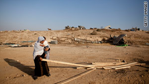 Nomads have been targets recently in the Sinai desert. A mother collected wood last week from her ruined home.