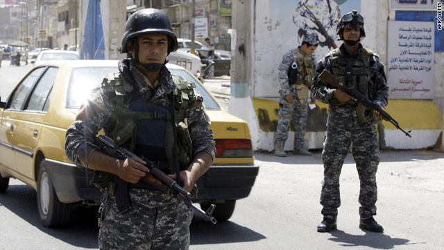 Iraqi soldiers on patrol in Baghdad on Thursday: The electoral commission worker was found shot dead in his car on Friday.