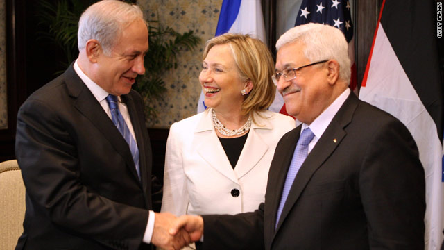 Israeli Prime Minister Benjamin Netanyahu, left, and Palestinian leader Mahmoud Abbas shake hands Tuesday as U.S. Secretary of State Hillary Clinton looks on.