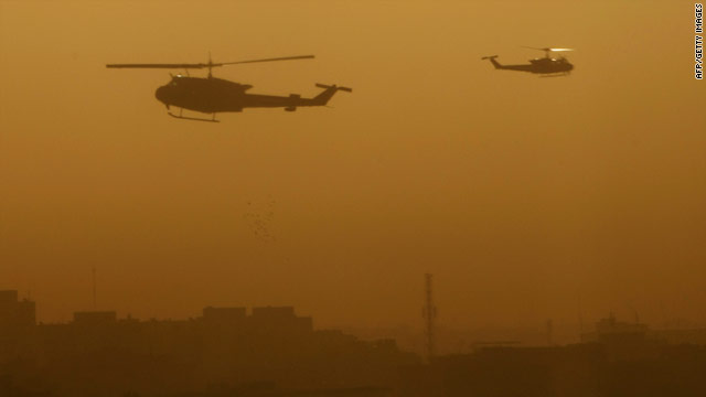 Military helicopters fly over Baghdad's Green Zone following an explosion on Monday.
