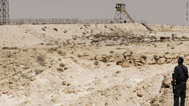 An Israeli policeman looks across to the Egyptian border.