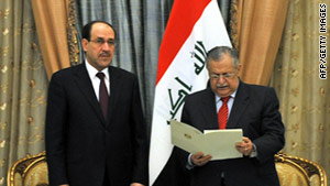 Iraqi President Jamal Talabani, right, names Nuri al-Maliki prime minister on Thursday.