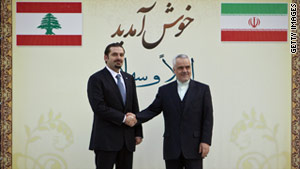 Lebanese Prime Minister Saad Hariri, left, shakes hands with Iran's first vice president, Mohammad Reza Rahimi.