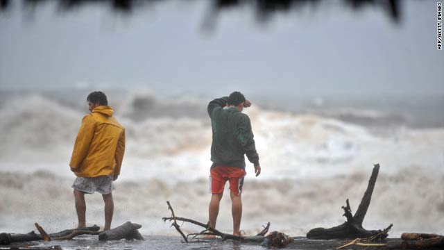 Two men watch heavy swells on Saturday in San Jose port, 110 kilometers south of Guatemala City, Guatemala.