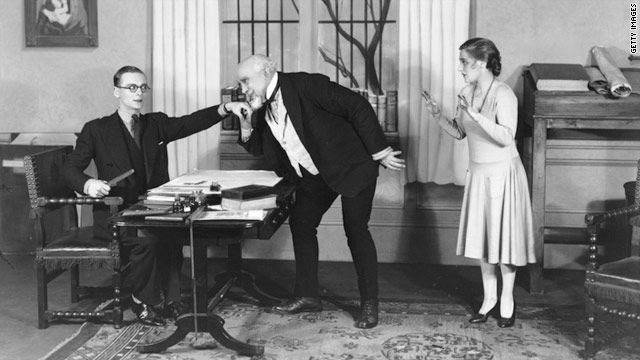 A man kisses the hand of his boss, in a scene from the play 'Fortunato',  19 October, 1928.