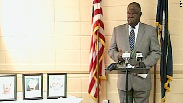 Tony Fisher, director of the Spartanburg Public Safety Department, stands next to photos of the three shooting victims.