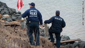 Police divers search for human remains in waters near Point Lookout, New York, in April.