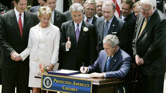 With John and Reve Walsh watching, President George W. Bush signs the Adam Walsh Act on July 27, 2006.