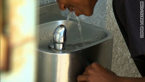 kid drinking water from fountain