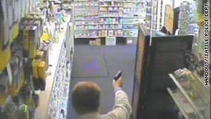 Surveillance video shows pharmacist Mike Donohue defending his drugstore with a pistol two years ago.
