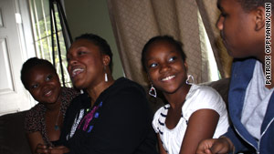 Tonya Rasberry sits with her children, from left, Erykah, 13, Tionne, 12, and Seaduan, 15.