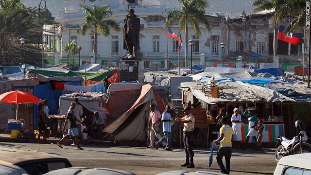 People displaced by the massive earthquake continue to live in tents in front the rubble of the Presidential Palace a year later.