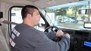 Adam Larsen takes the wheel as his caravan team leaves a Tampa, Florida, RV park.