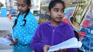 Arianna Ramrajie, 7, right, joins her sister, Breana, 8, in sharing the doomsday message.