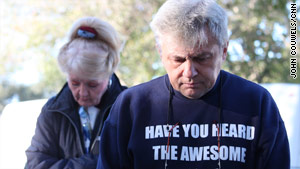 Sheila Jonas, left, and Les Ambroziak bow their heads in prayer before facing a new day.