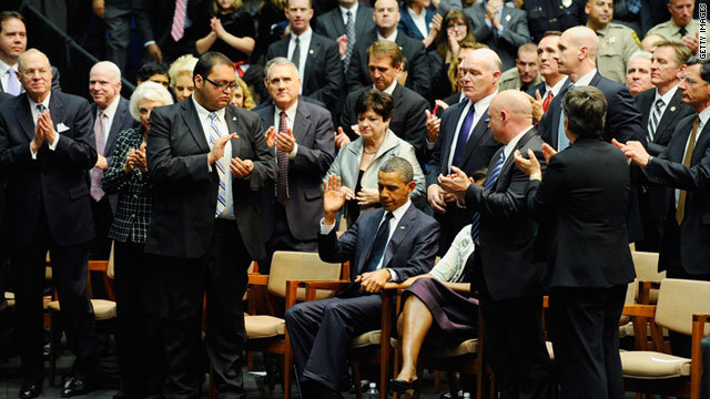 President Barack Obama acknowledges applause after his speech at the memorial service for Tucson shooting victims.