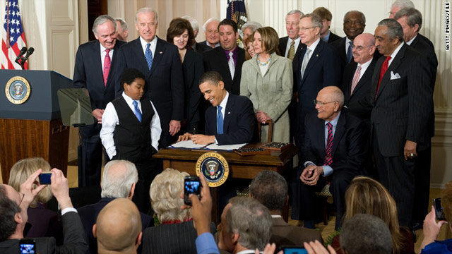 President Barack Obama signs the health care law during a ceremony in the East Room of the White House March 23, 2010.