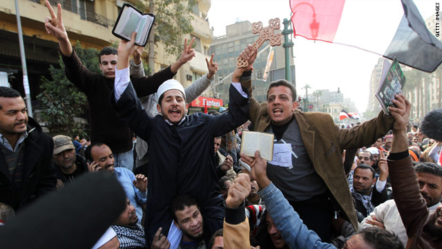 Coptic Christians and Muslims raise a Cross and a Koran at Cairo's Tahrir Square on February 6.