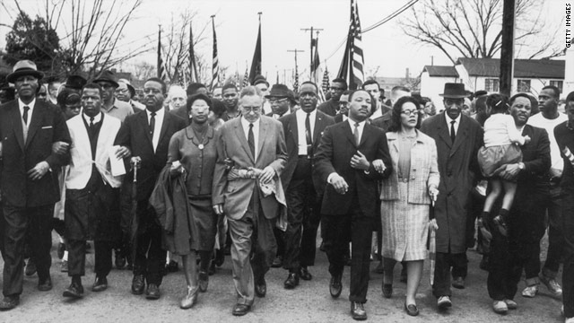 Martin Luther King and his wife, Coretta Scott King, lead a black voting rights march from Selma, Alabama, to the state capital.