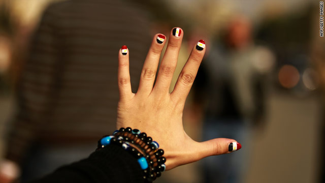 An Egyptian girl flashes her nails painted with the colors of her national flag in Cairo's Tahrir Square.