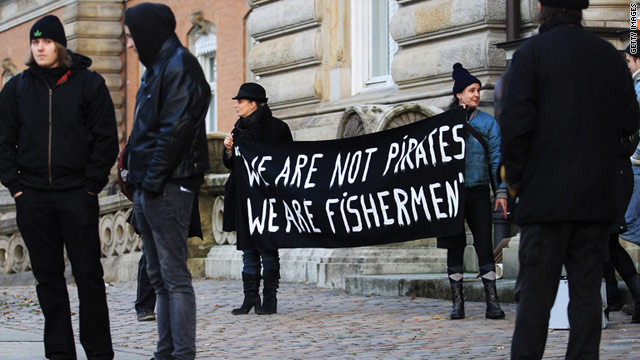 Demonstrators hold banners during a trial against Somali pirates in Hamburg, Germany, in November.