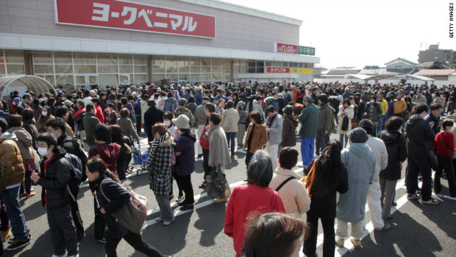 People line up to buy food and daily necessities at a supermarket in Sendai city, Miyagi prefecture, on Monday