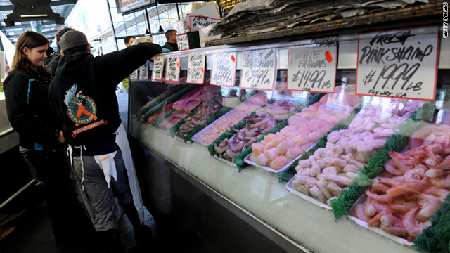 A customer checks out the seafood at The Pike Place Fish market in Seattle, Washington.