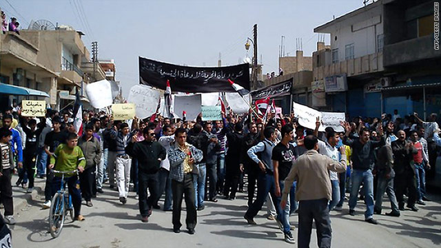 Syrian anti-government protesters march in the northeastern town of Qamishli on Friday, April 1.