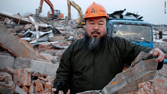 Chinese artist Ai Weiwei  holds debris from his newly built Shanghai studio after the government demolished it without warning.