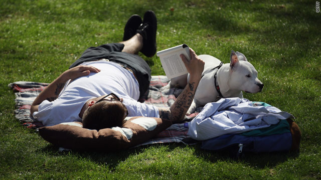 A man and his dog relax in the sunshine in Rembrandt Gardens, Little Venice on April 8, 2011 in London, England.