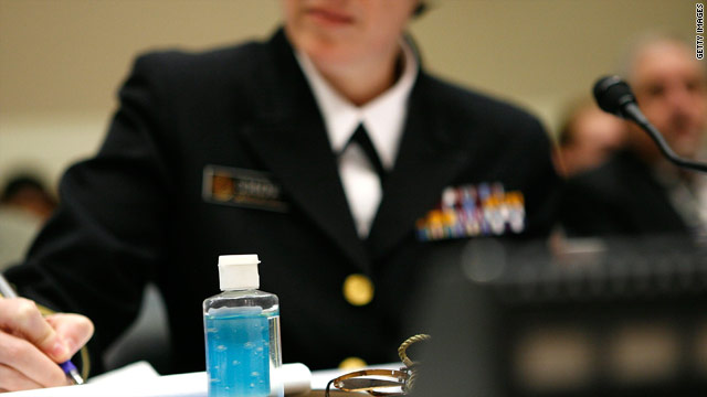 A bottle of hand sanitizer sits on a table as Rear Adm. Anne Schuchat testifies at a 2009 House panel hearing on the H1N1 virus.