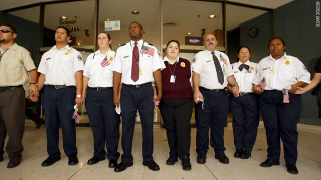 TSA employees hold hands around a memorial to the victims of the September 11 terror attacks at Los Angeles International Airport in 2003.