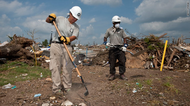 AmeriCorps members taking part in a team effort rake debris on June 18 after a torndao in Joplin, Missouri.