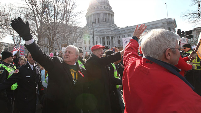 Democratic state senators greet supporters as they march around the Capitol with protesters on Saturday in Madison.