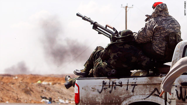 Libyan rebels under fire withdraw from the western edge of Ajdabiyah on April 8, 2011.