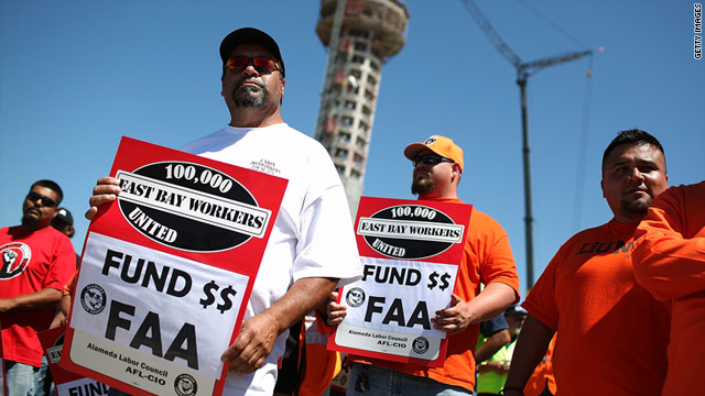 Union workers hold signs in Oakland, California, last month, asking for a long-term solution to fund the FAA.