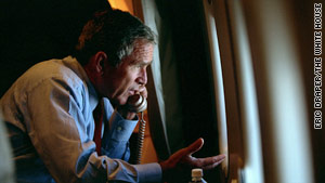 As Air Force One approaches Washington, Bush talks with Vice President Cheney while looking at the smoldering Pentagon.
