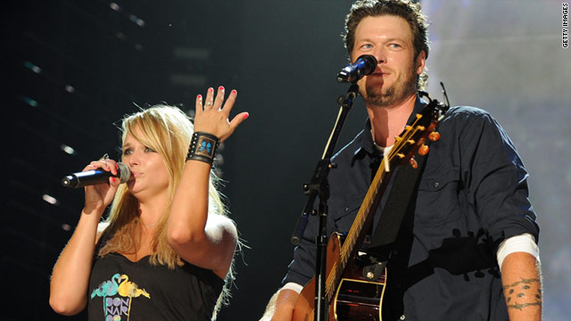 Miranda Lambert shows off her engagement ring to the crowd during a concert with Blake Shelton in 2010.