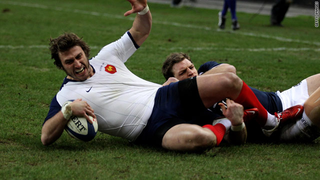 France winger Maxime Medard crosses for his team's opening try against Scotland in Paris on Saturday.