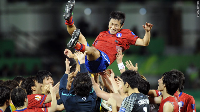 Lee Young-Pyo's South Korea teammates throw him into the air after they beat Uzbekistan.